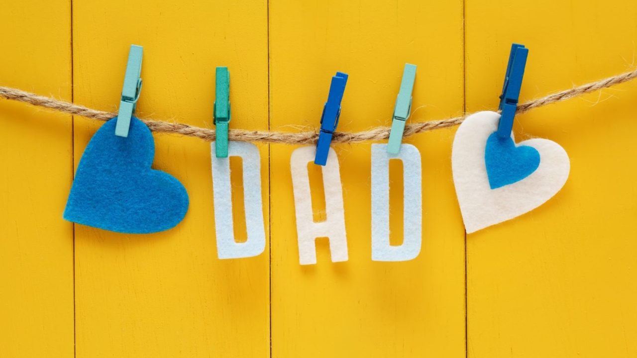 Felt letters spelling dad pegged to a string