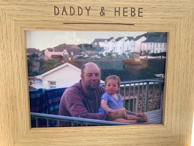 Hebe as a baby with her dad in a wooden frame with Daddy and Hebe written on