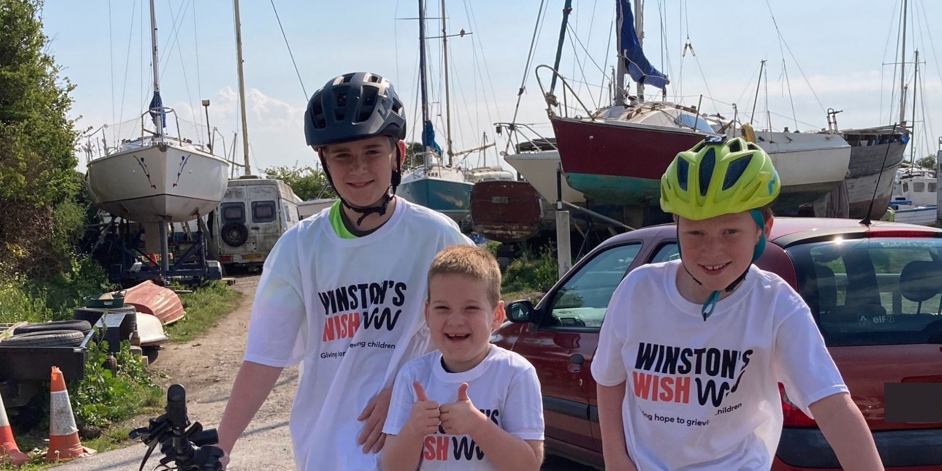 Three young boys in Winston's Wish t-shirts