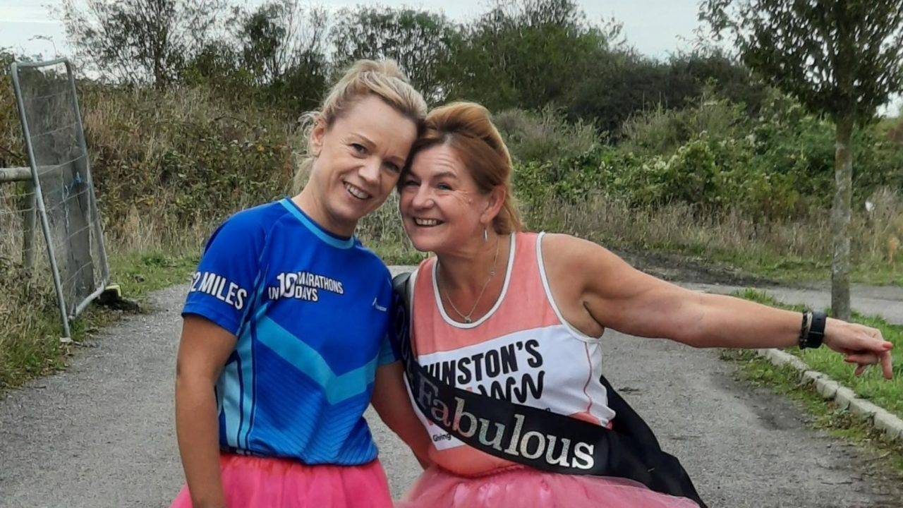 marie and friend after running her 100th marathon