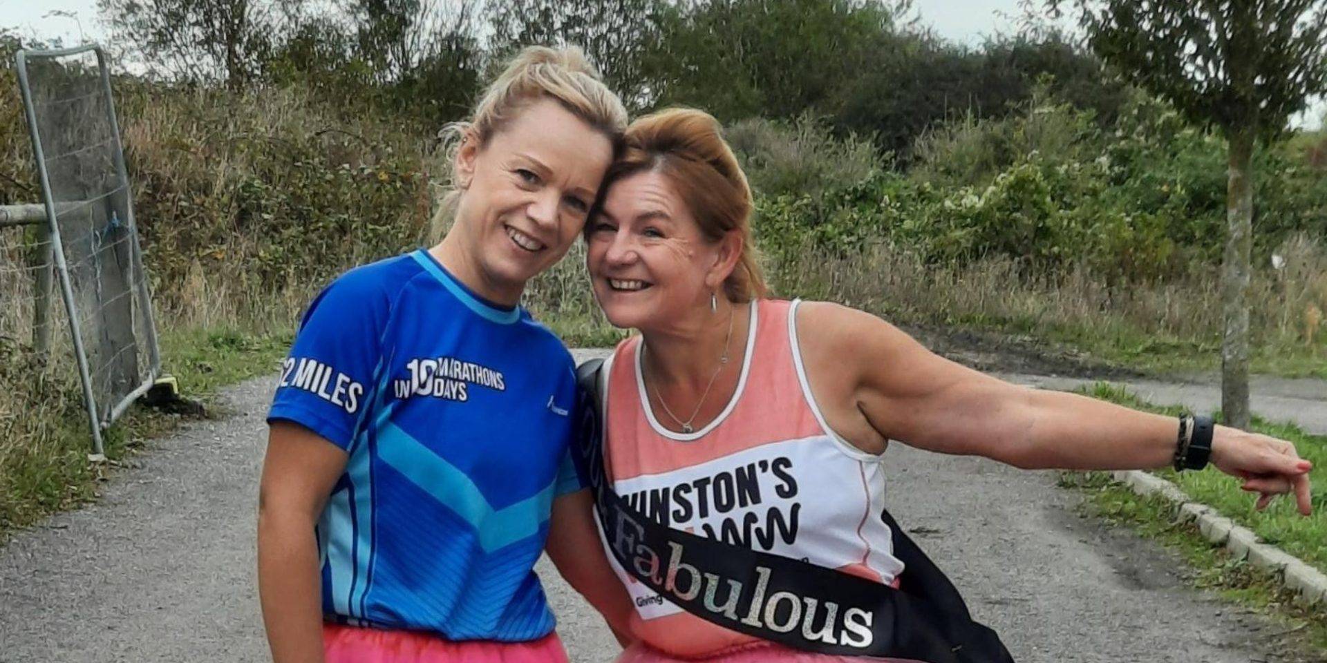 marie and friend after running her 100th marathon