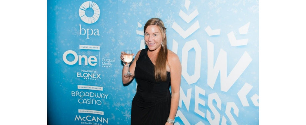 Jo Harrington wearing black evening dress and holding glass of wine at BPA event