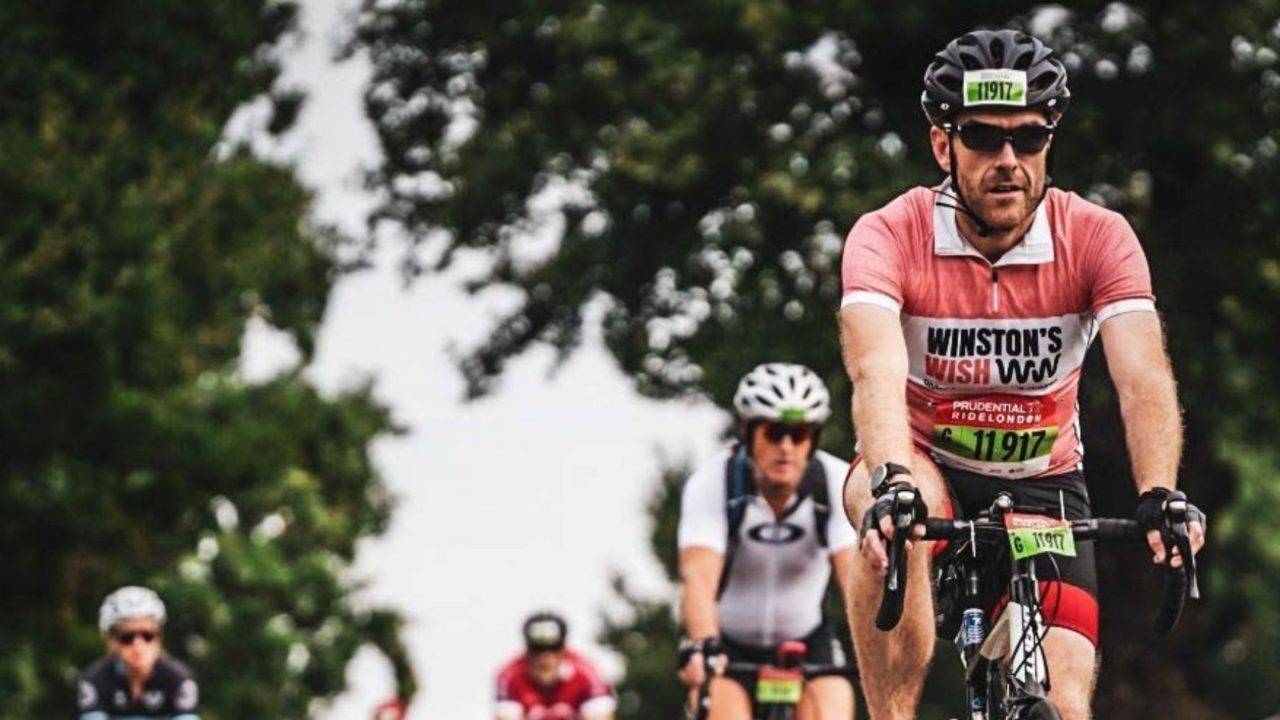 Russ brookes cycling for Winston's Wish in coral jersey