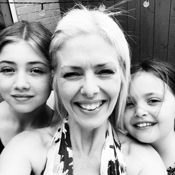 Black and white photo of Debbie, Lizzie and Hattie smiling