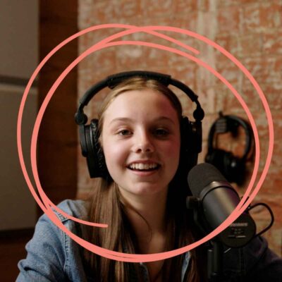 Teenage girl with headphone on in front of a microphone - Winston's Wish Young Ambassador