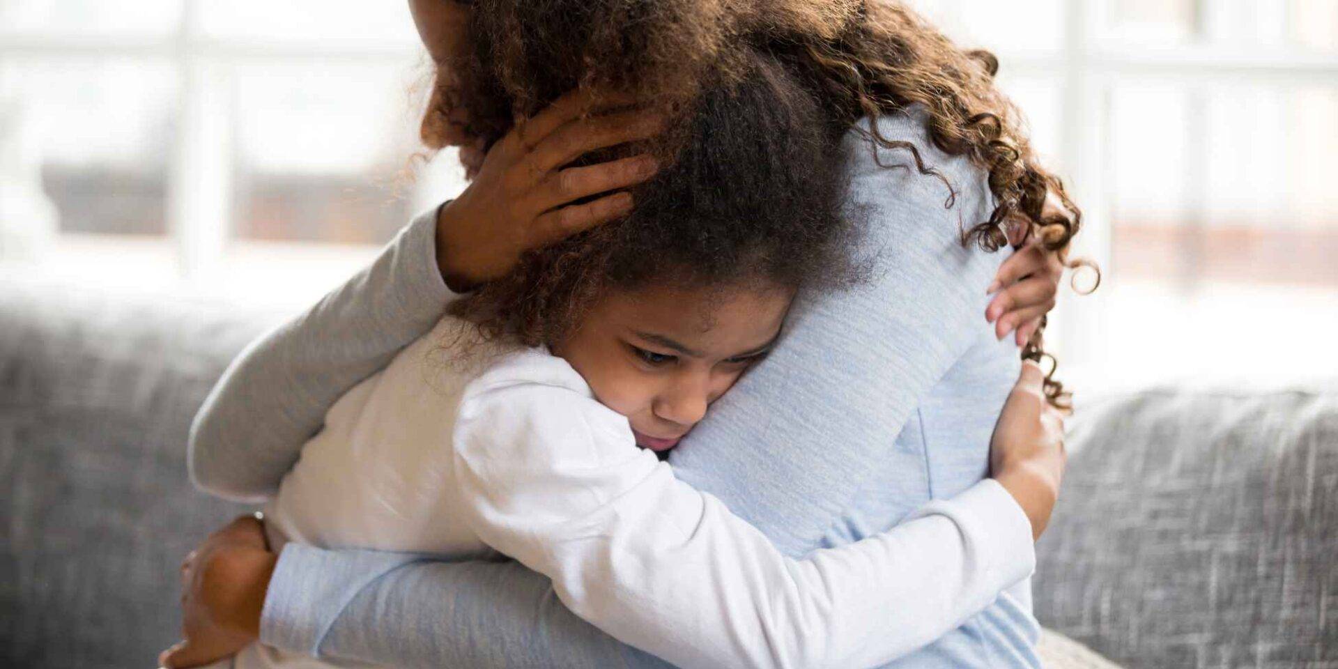 Mother and young daughter hugging - Managing separation anxiety in children after a bereavement - Winston's Wish