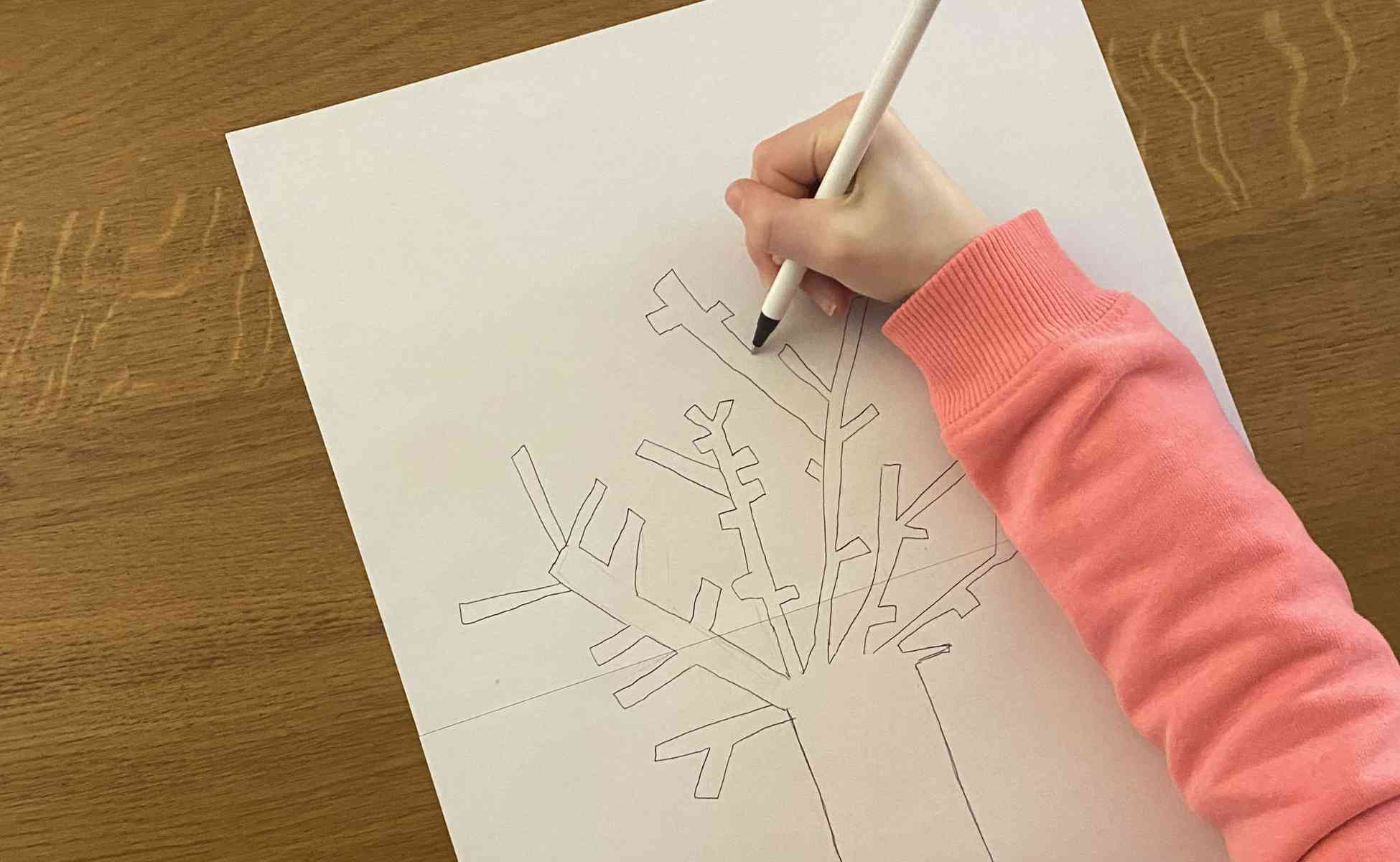 Photo of a child drawing branches of a tree - Thankful tree, step 3
