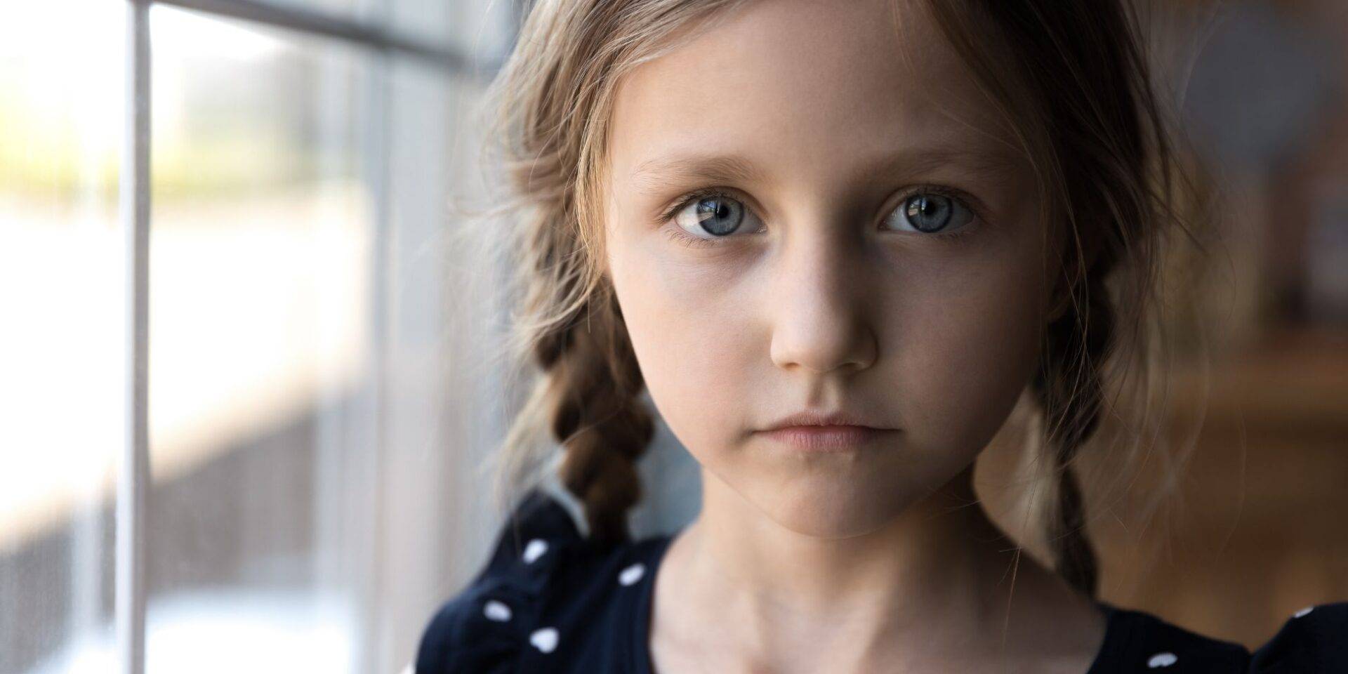 A young girl looking at the camera