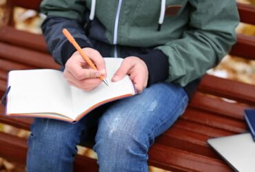 Young person writing in a notebook