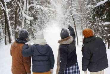 Four young people in a snowy forest