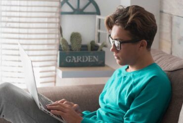 Teenage boy on laptop engaging in grief support services